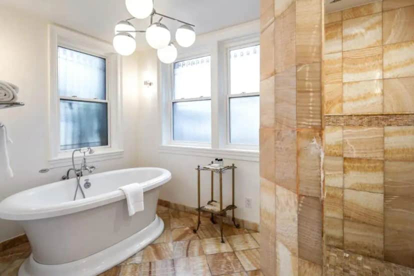 a white bathroom with a tub and a shower at Swann House in Washington, D.C.