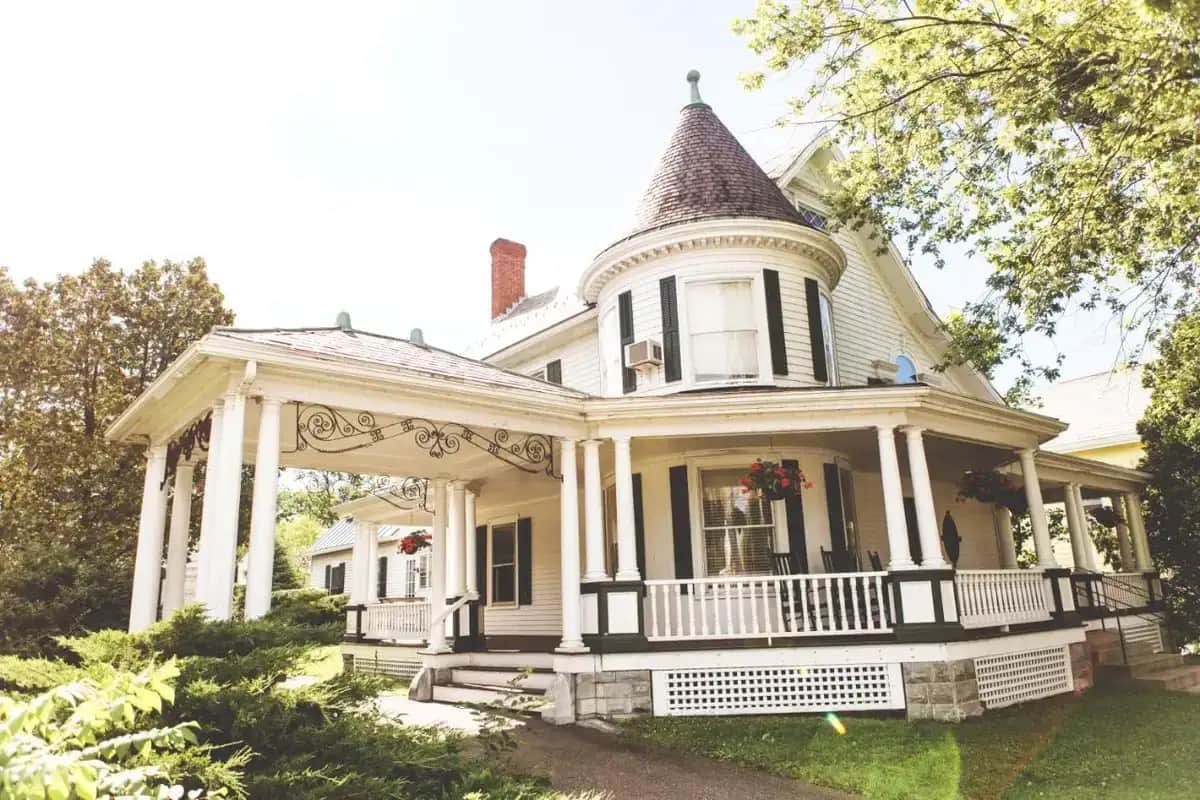 a white house with a turret on the front of it at Swift House Inn in Middlebury