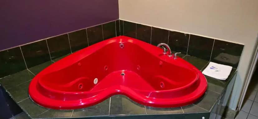a red sink in the corner of a bathroom at Texas Inn and Suites RGV in Edinburg