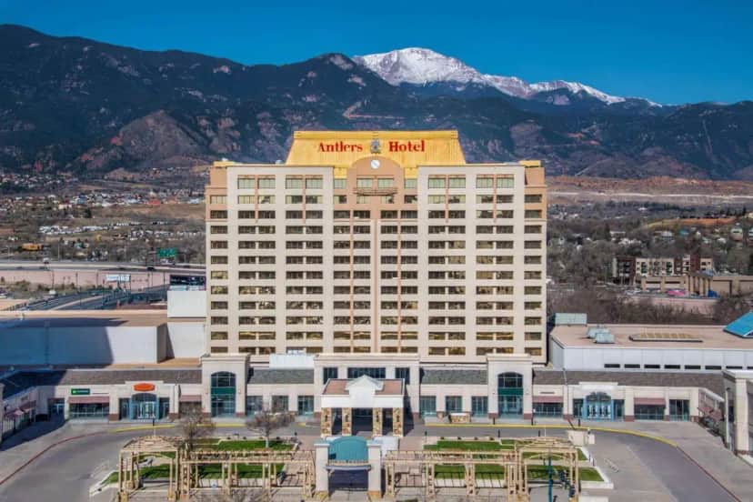 a hotel building with a mountain in the background at The Antlers, a Wyndham Hotel in Colorado Springs