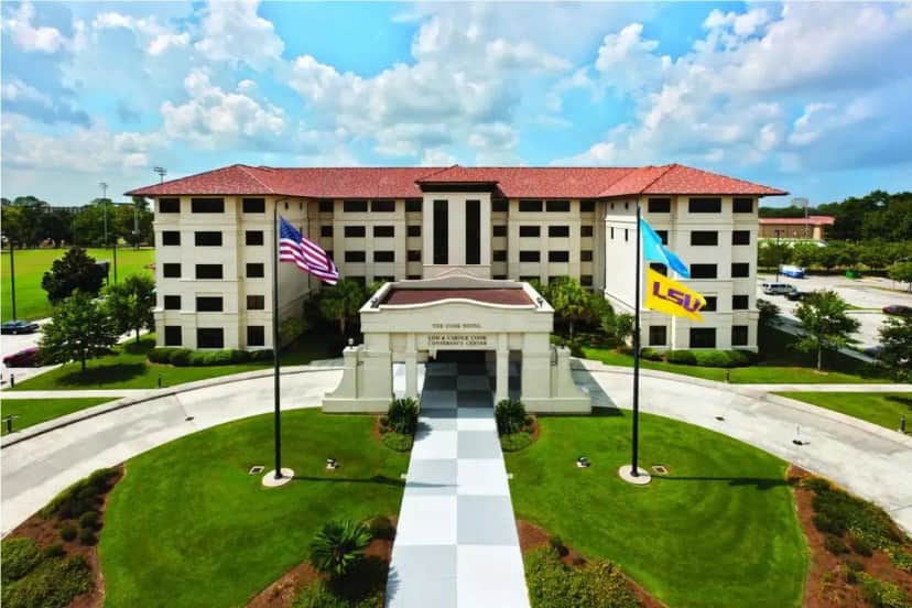 a building with two flags in front of it at The Cook Hotel and Conference Center at LSU in Baton Rouge