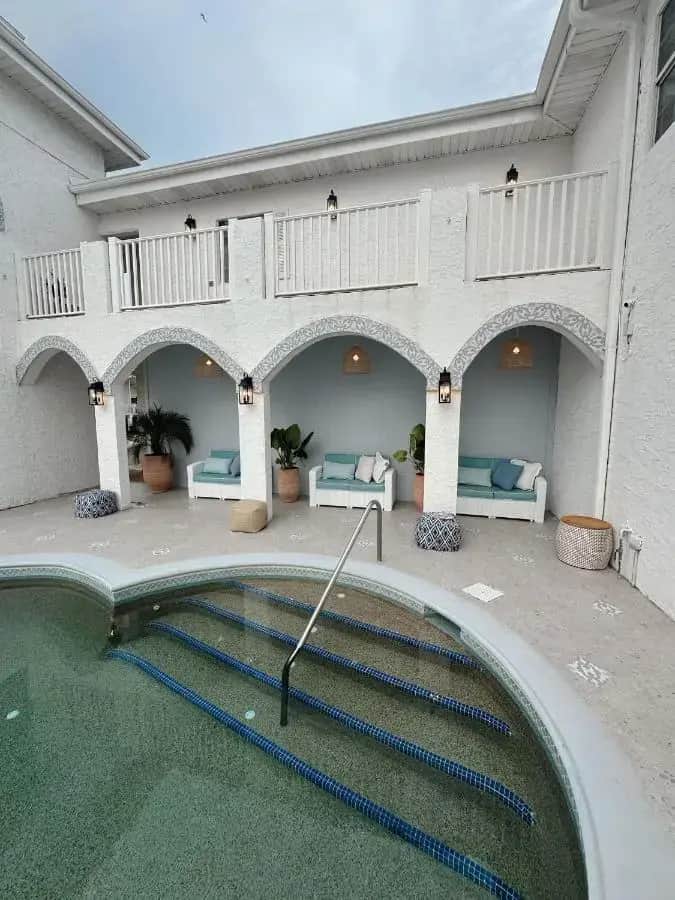 a house with a swimming pool in the courtyard at The Flamingo - South Padre Island in South Padre Island