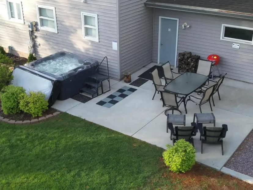 a patio with a table and chairs and a hot tub at The Hemlock/Hot Tub/Golf/Private Yard in Spring Green