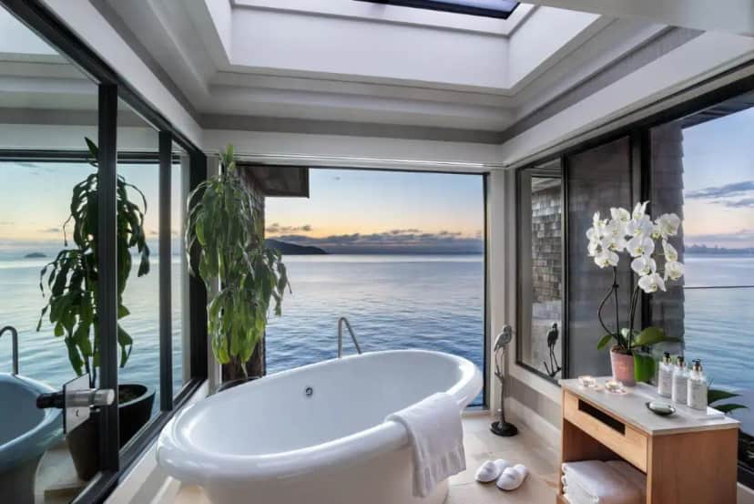 a bathtub in a bathroom with a view of the ocean at The Inn Above Tide in Sausalito