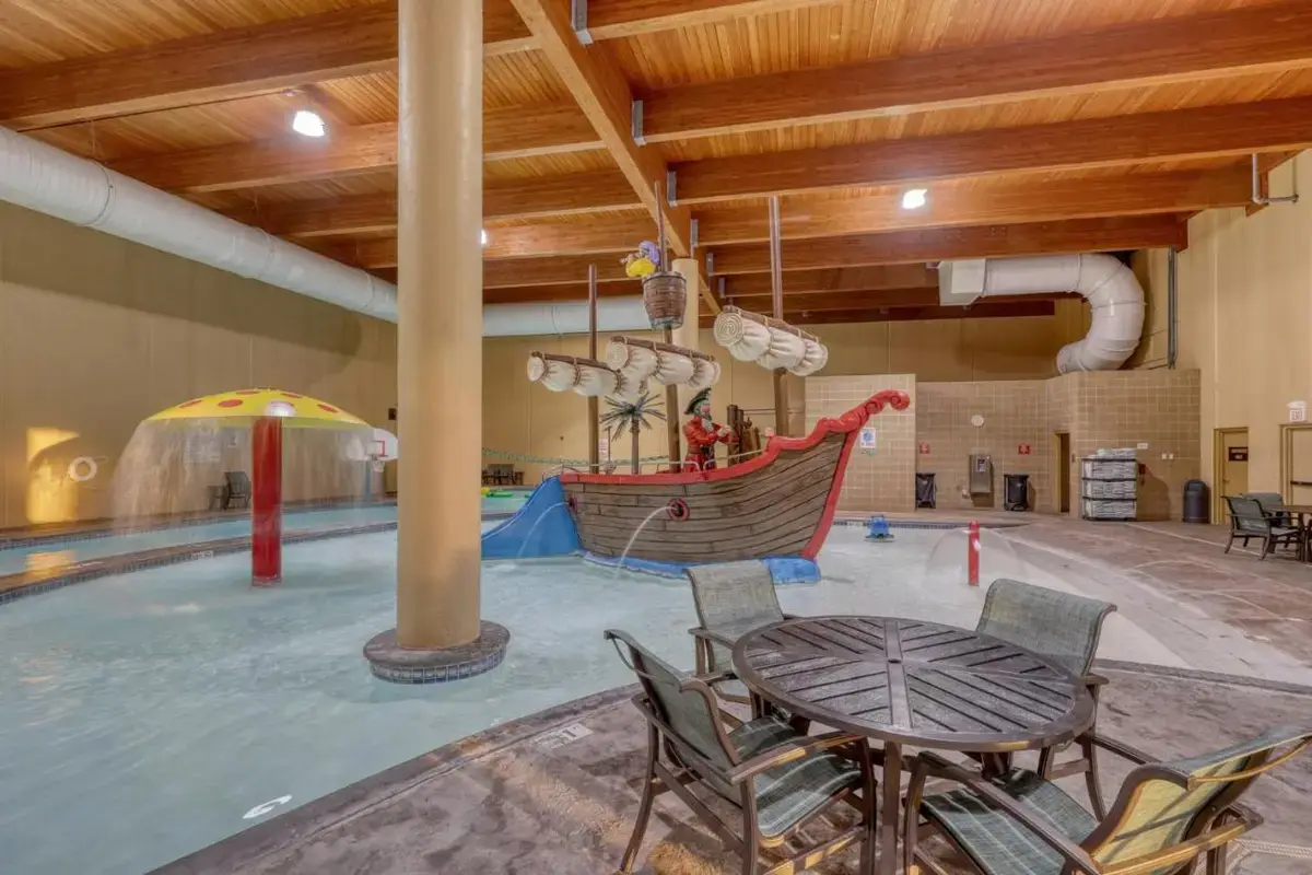 a large indoor pool with a table and chairs at The Lodge at Deadwood in Deadwood