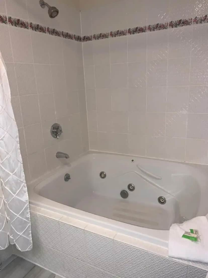 a white bath tub in a bathroom at The Lodge at Jackson Village in Jackson