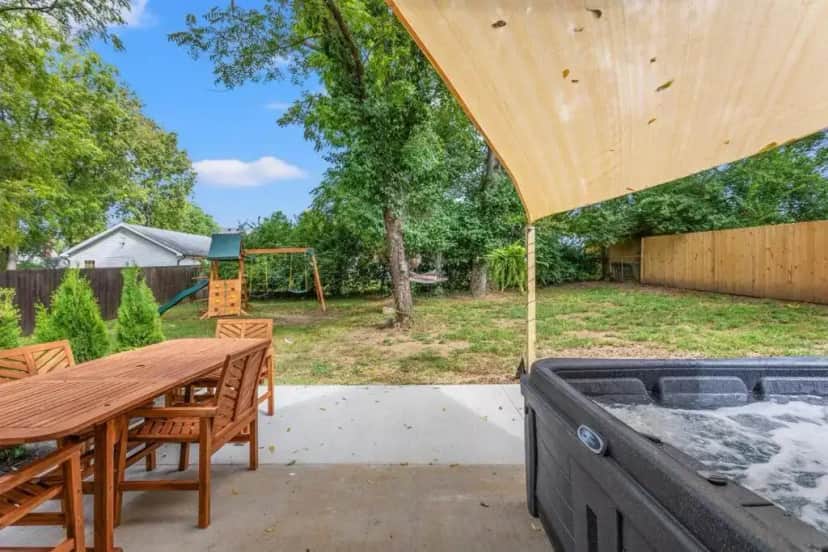a backyard with a wooden table and a sandbox at The Luxe/HotTub/Playground/12min KHP/30min Ark in Georgetown