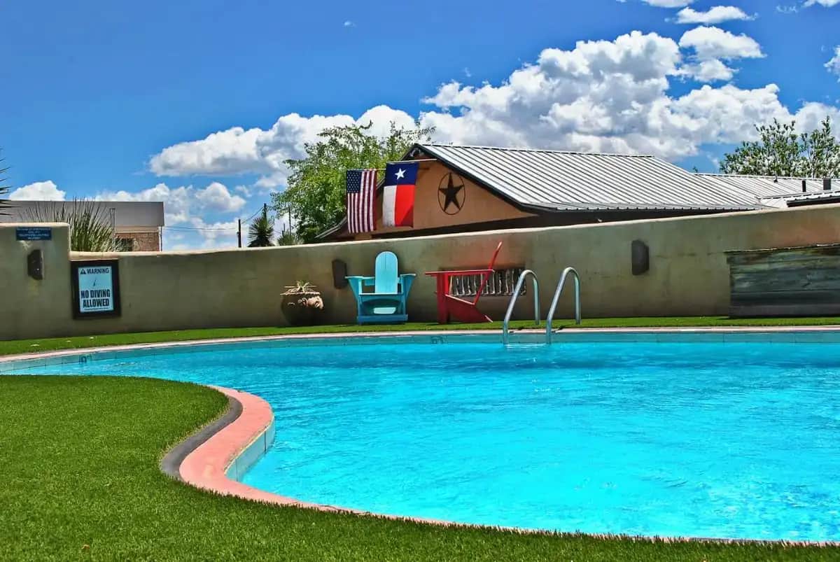 a swimming pool in front of a house at The Maverick Inn in Alpine