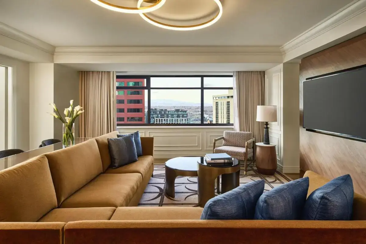 a living room with a couch and a flat screen tv at The Ritz-Carlton, Denver in Denver