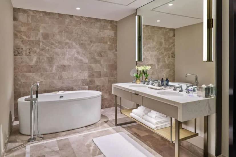 a bathroom with a tub and a sink at The St. Regis Chicago in Chicago