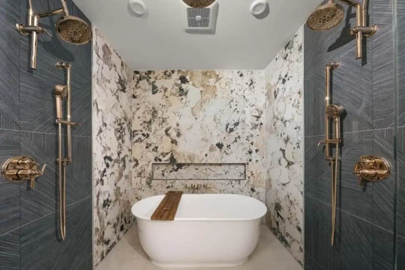 a bathroom with a toilet and a tub in it at The Star on Spring in Springdale