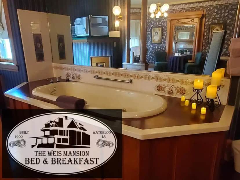 a bathroom with a tub and a sign that says the west mansion bed and breakfast at The Weis Mansion Bed and Breakfast in Waterloo