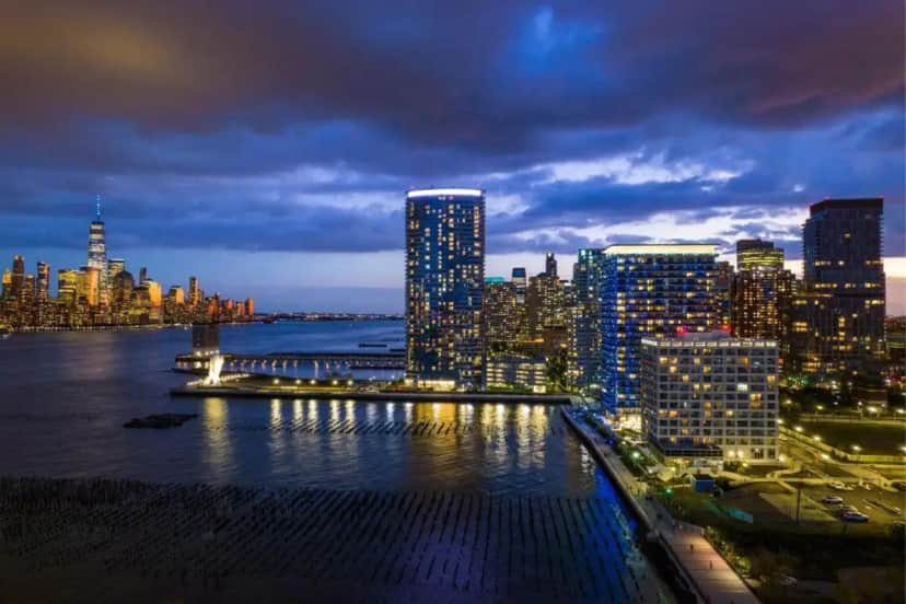 a view of a city skyline at night at The Westin Jersey City Newport in Jersey City