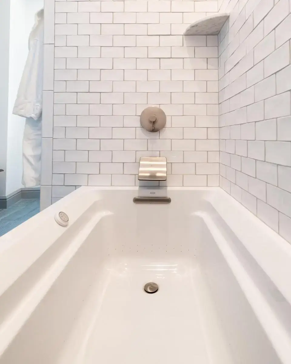 a white bath tub with a clock on top of it at The Whaler's Inn in Mystic