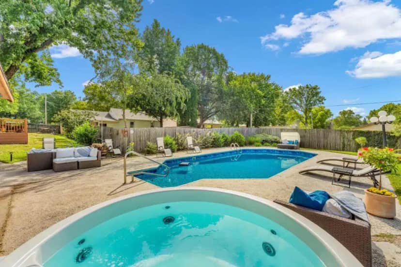 a swimming pool in a backyard with a patio furniture at The Wreath House in Manhattan in Manhattan