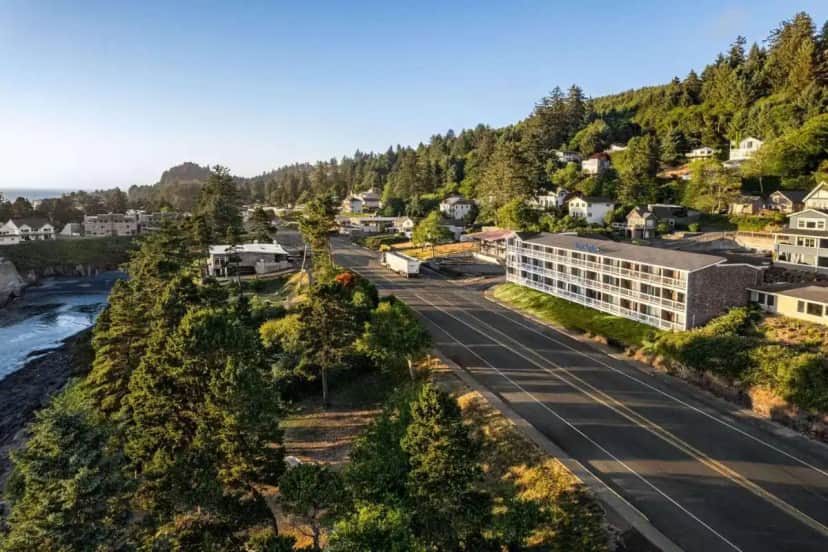 an aerial view of a town next to a river at Travelodge by Wyndham Depoe Bay in Depoe Bay