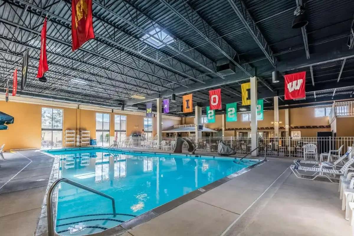 a large indoor swimming pool with blue water at Quality Inn University Lansing in Lansing