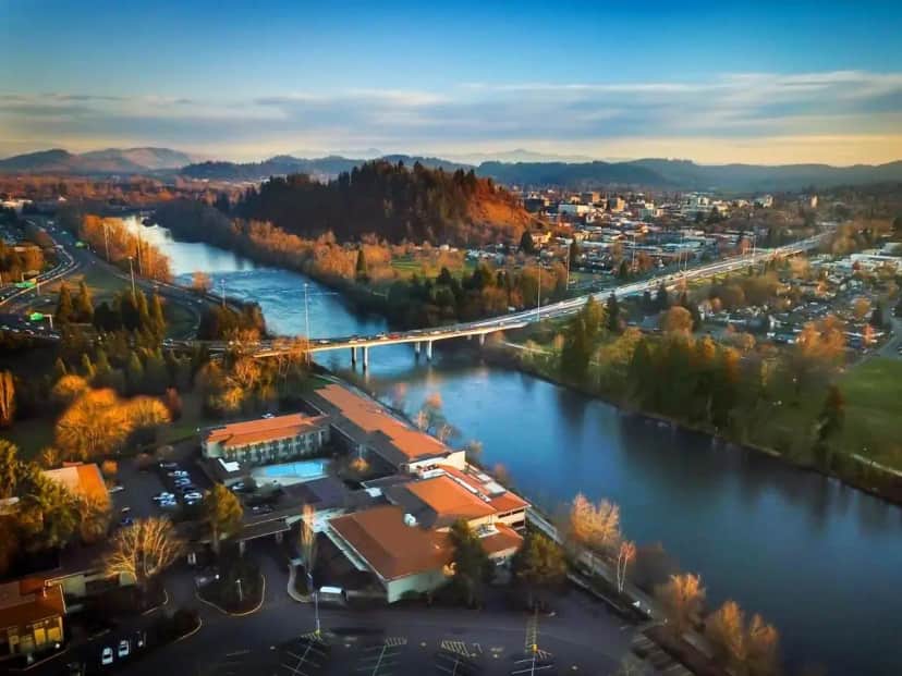 an aerial view of a river and a city at Valley River Inn in Eugene