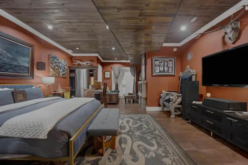 a bedroom with a large bed and a flat screen tv at Villa D' Citta in Chicago