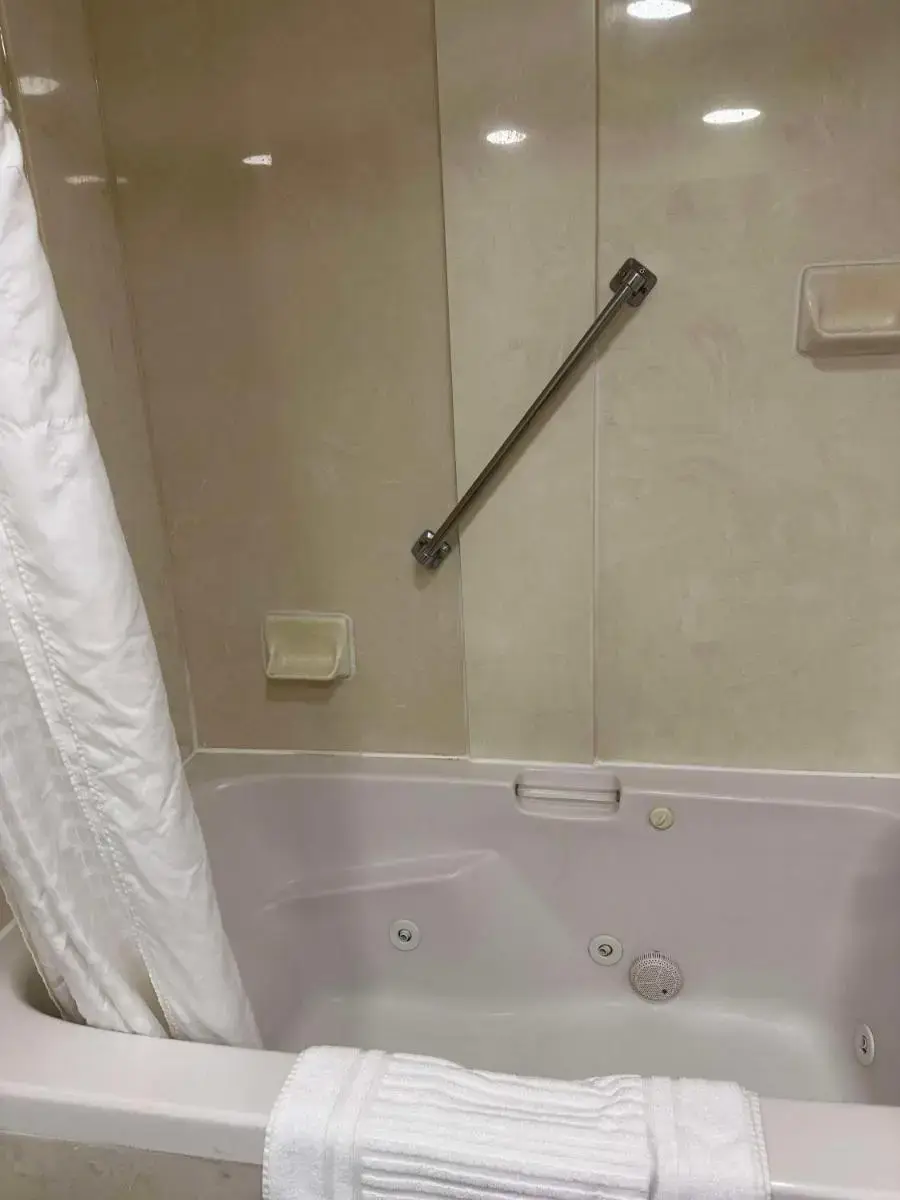 a bathroom with a bath tub with a shower curtain at Vista Suites Near Island and Leconte Convention Center in Pigeon Forge