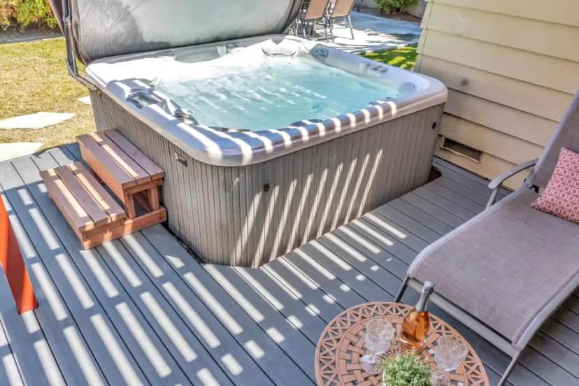a hot tub on a deck with a chair and a table at Walk To Disneyland, Watch Firework Front Yard, SPA in Anaheim