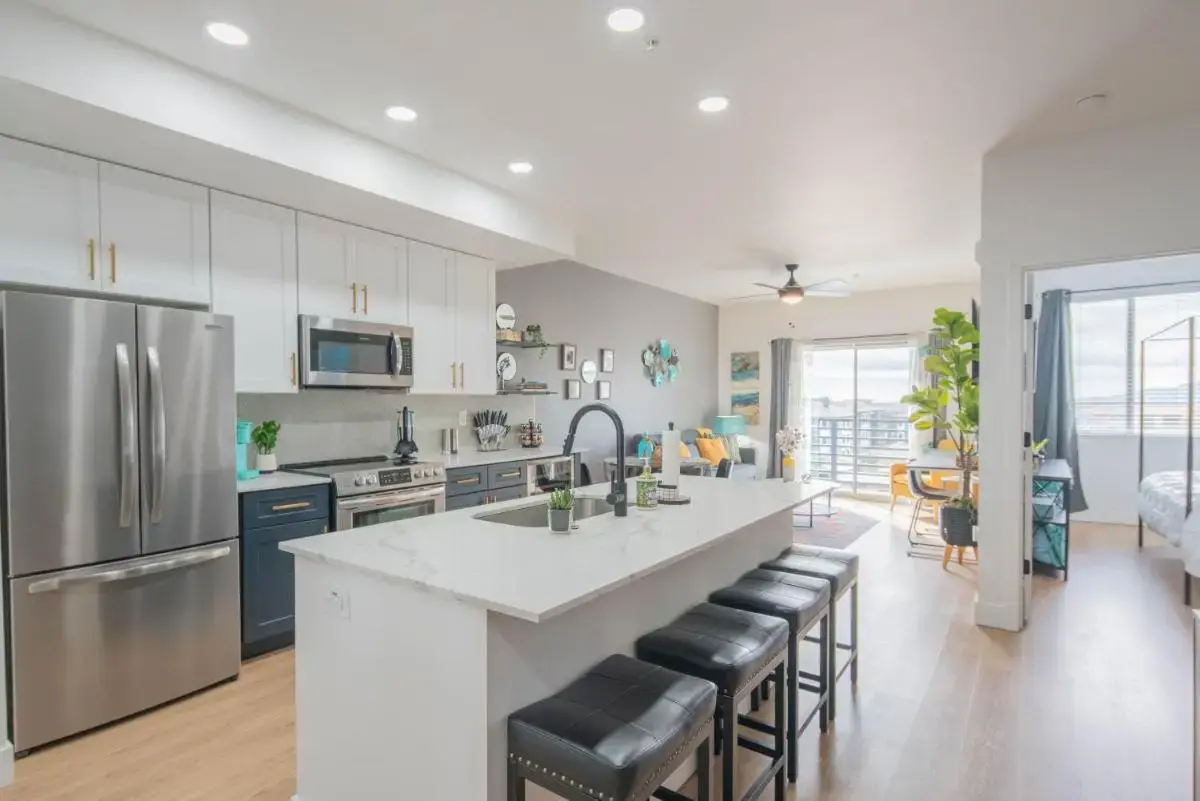 a kitchen with a large island with bar stools at Warm Summer Vibes Kierland Area Pool & Hot Tub in Scottsdale