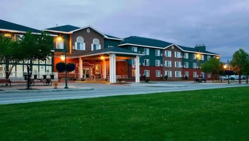 a large building with a park in front of it at Wingate by Wyndham Anchorage Downtown - Ship Creek in Anchorage