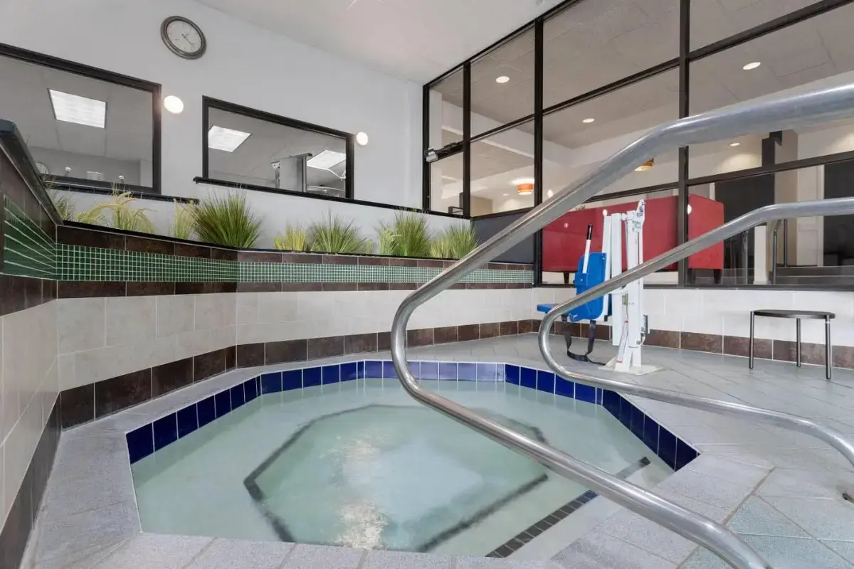 a swimming pool with a hot tub in a building at Wyndham Minneapolis South Burnsville in Burnsville