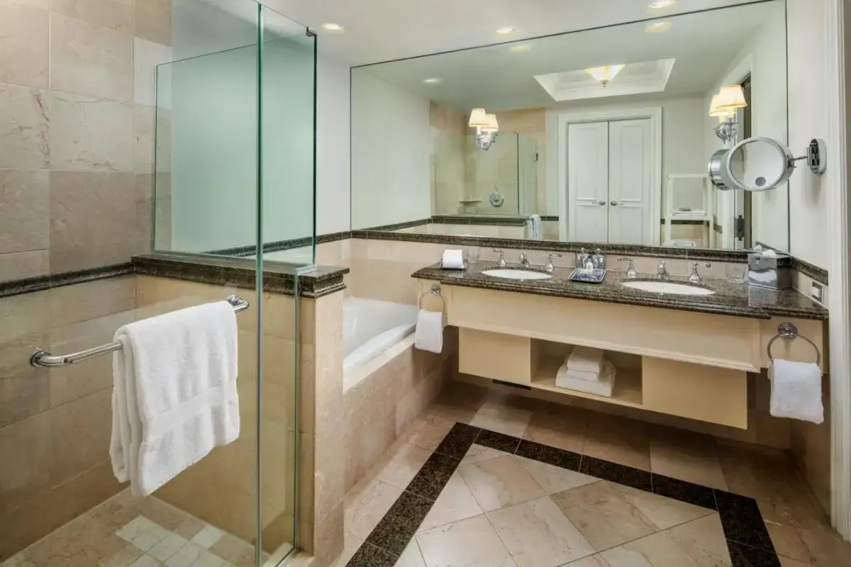 a bathroom with a sink and a tub and a mirror at Yacht Club at The Boca Raton Adults-only in Boca Raton