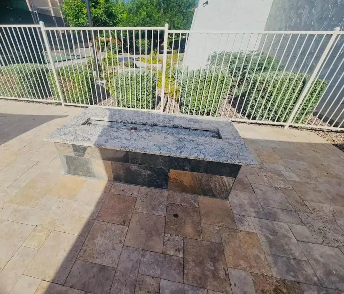 a stone bench sitting in front of a fence at Your Scottsdale Paradise with Pool, Tennis, Gym and Hot Tub in Scottsdale