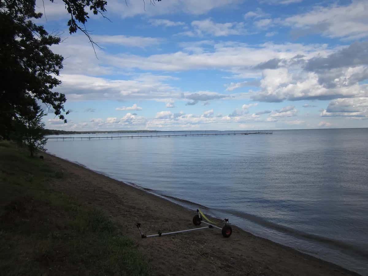 Pine-lined lakeshore and dock in Minnesota lakes country